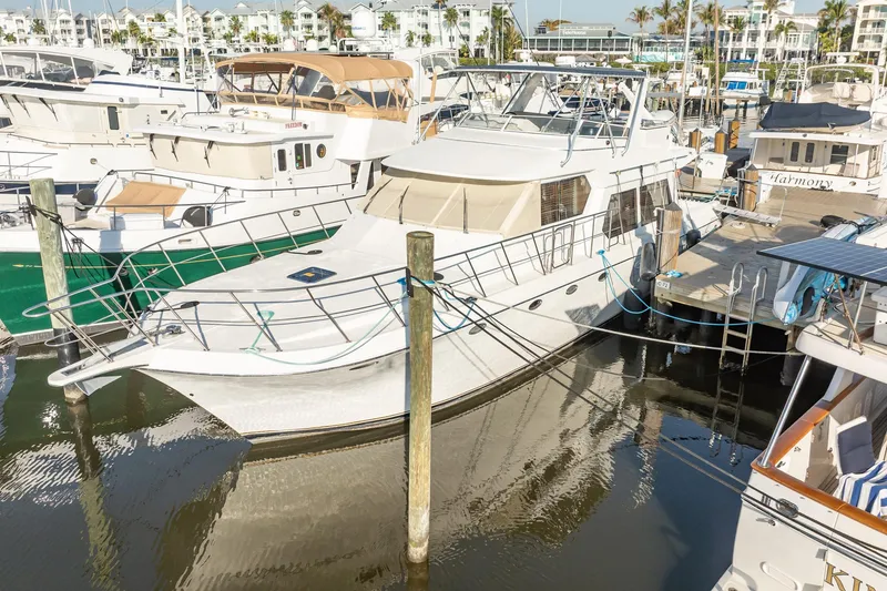 Slide: The Image of 2004 Navigator 5700 Rival Pilothouse yacht docked in a marina. - 4