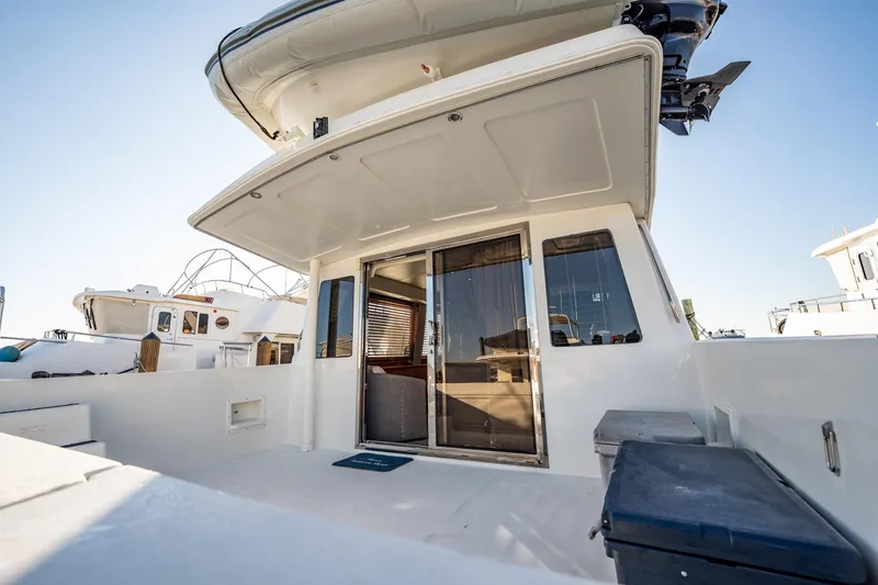 Slide: The Image of 2004 Navigator 5700 Rival Pilothouse yacht with spacious deck and sliding glass doors. - 7