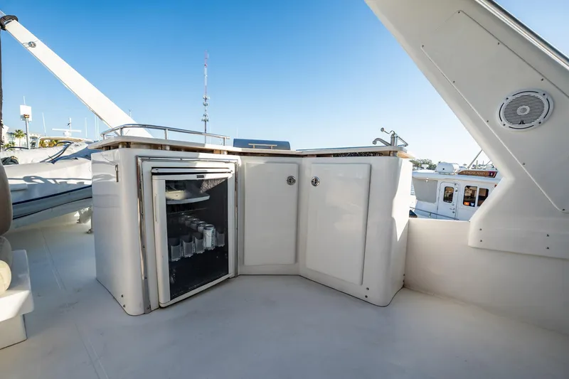 Slide: The Image of 2004 Navigator 5700 Rival Pilothouse yacht with outdoor mini fridge and storage cabinets. - 9