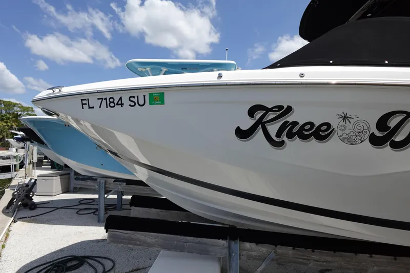 Slide: The Image of 2021 Regal 23 OBX boat docked, displaying registration FL 7184 SU under a clear sky. - 12