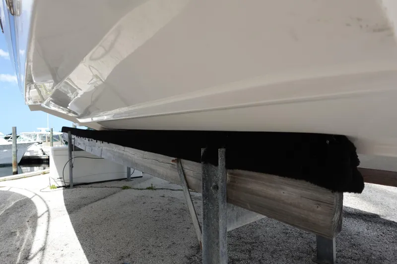 Slide: The Image of 2021 Regal 23 OBX boat hull on a dock, side view. - 14
