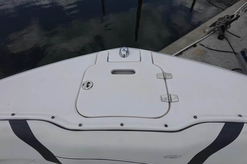 Slide: The Image of Bow of a 2021 Regal 23 OBX boat docked by the water. - 15
