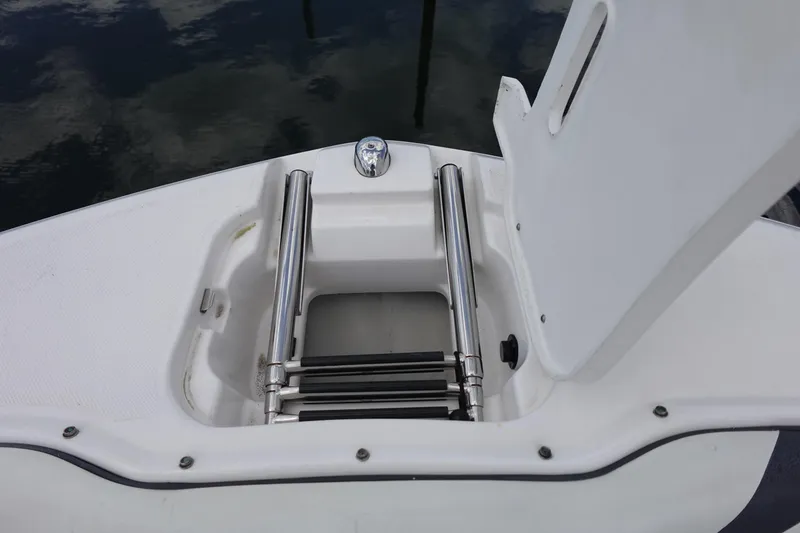 Slide: The Image of 2021 Regal 23 OBX boat with open hatch and retractable ladder. - 16