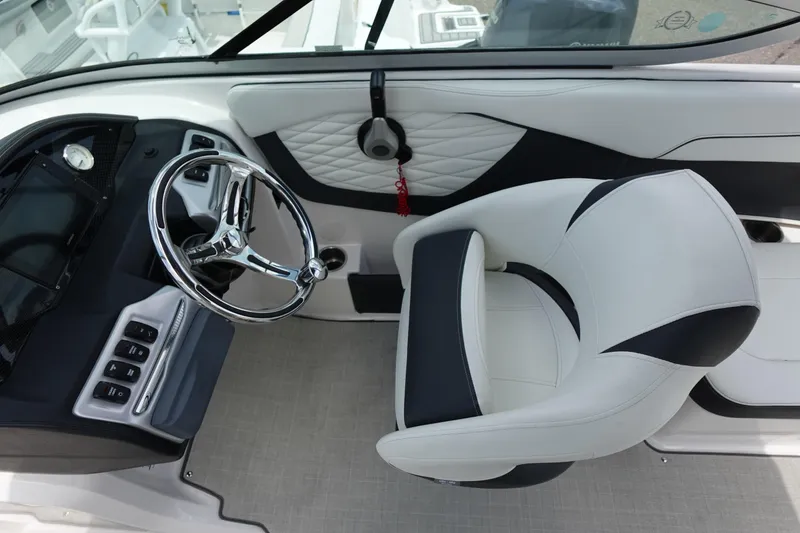 Slide: The Image of 2021 Regal 23 OBX boat interior with sleek steering wheel and modern dashboard design. - 23