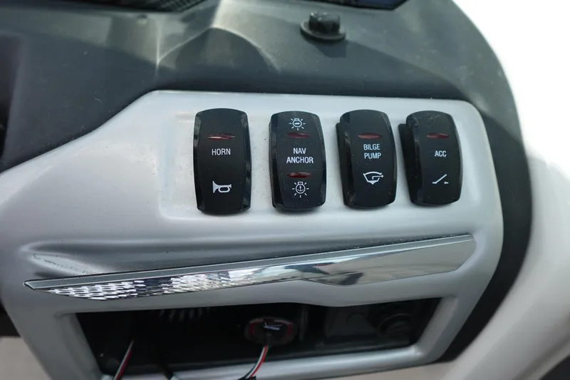 Slide: The Image of Control panel of a 2021 Regal 23 OBX boat with labeled switches. - 28