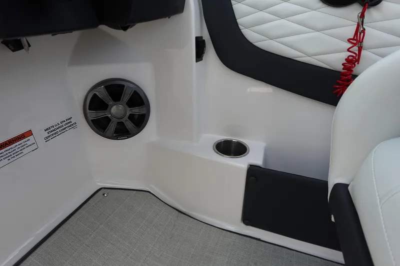Slide: The Image of 2021 Regal 23 OBX boat interior with speaker, cup holder, and quilted upholstery. - 29