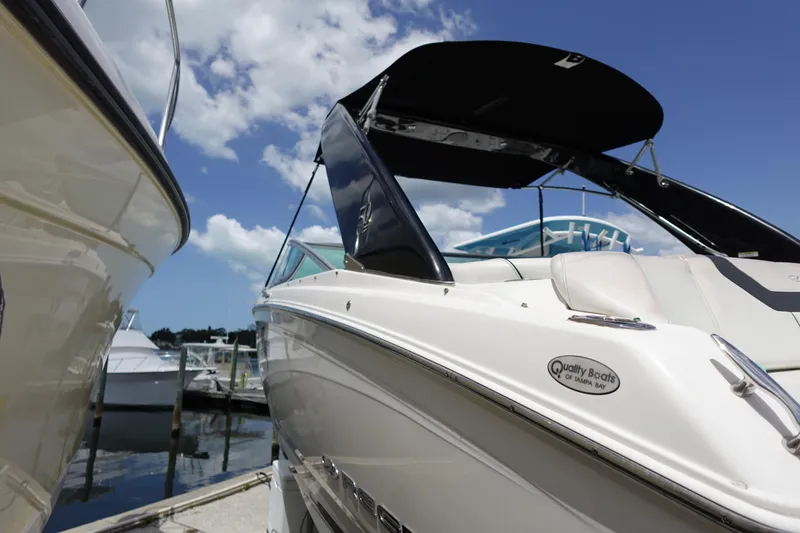 Slide: The Image of 2021 Regal 23 OBX boat docked under a clear blue sky. - 3