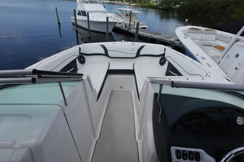 Slide: The Image of 2021 Regal 23 OBX boat interior with seating, docked near other boats. - 32