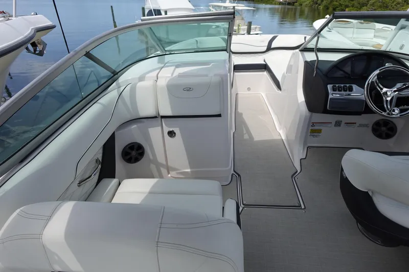 Slide: The Image of 2021 Regal 23 OBX boat interior with white seating and sleek dashboard design. - 33