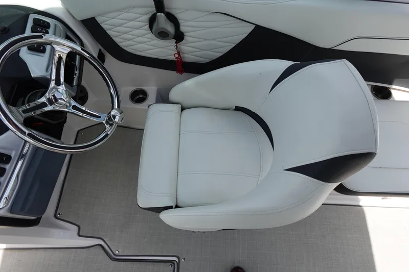 Slide: The Image of Captain's seat and steering wheel of 2021 Regal 23 OBX boat interior. - 35