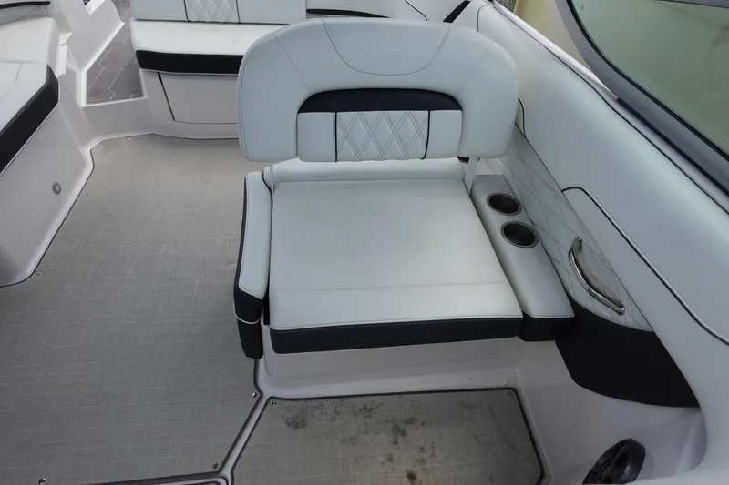 Slide: The Image of 2021 Regal 23 OBX boat interior with white seating and cup holders. - 36