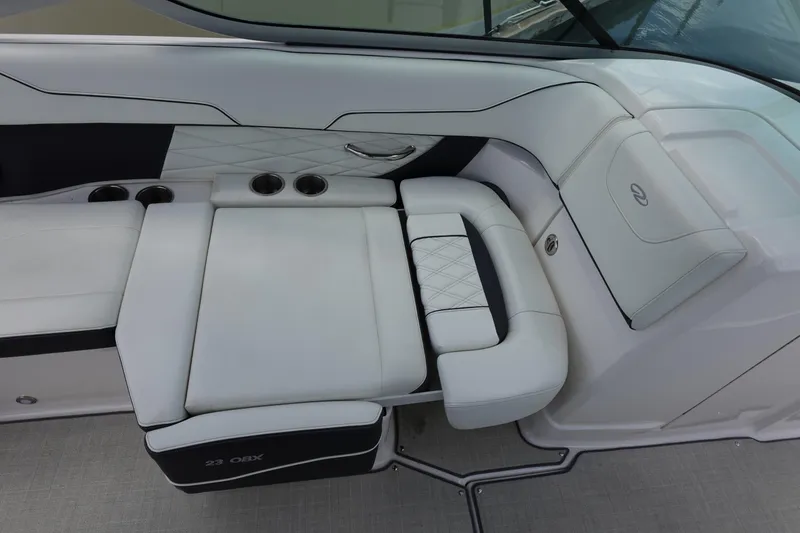 Slide: The Image of 2021 Regal 23 OBX boat interior with white cushioned seating and cup holders. - 37