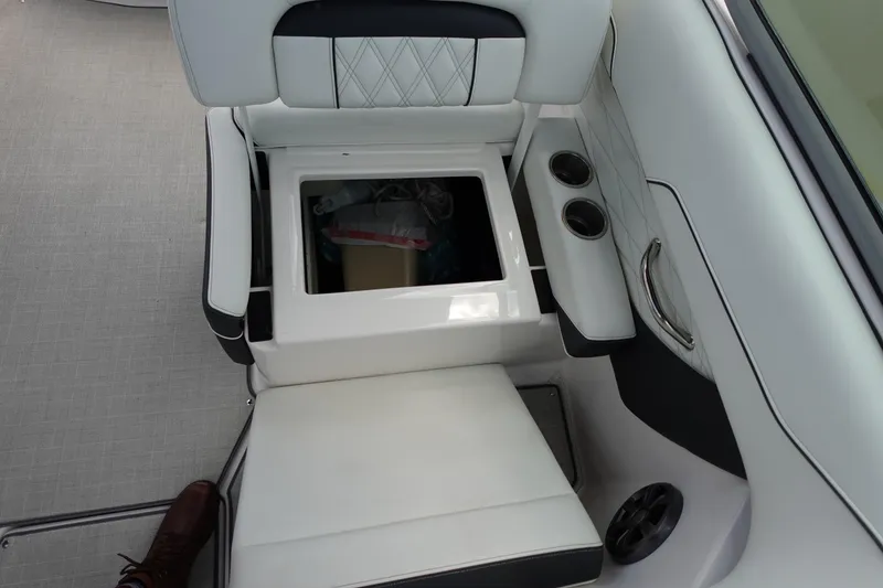 Slide: The Image of 2021 Regal 23 OBX boat interior with open storage compartment and cup holders. - 38