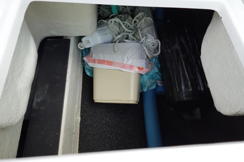 Slide: The Image of Storage compartment in a 2021 Regal 23 OBX boat with ropes and equipment. - 39