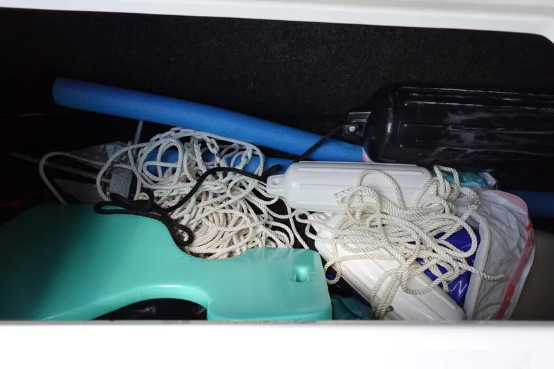 Slide: The Image of Storage compartment of a 2021 Regal 23 OBX boat with ropes and accessories. - 43