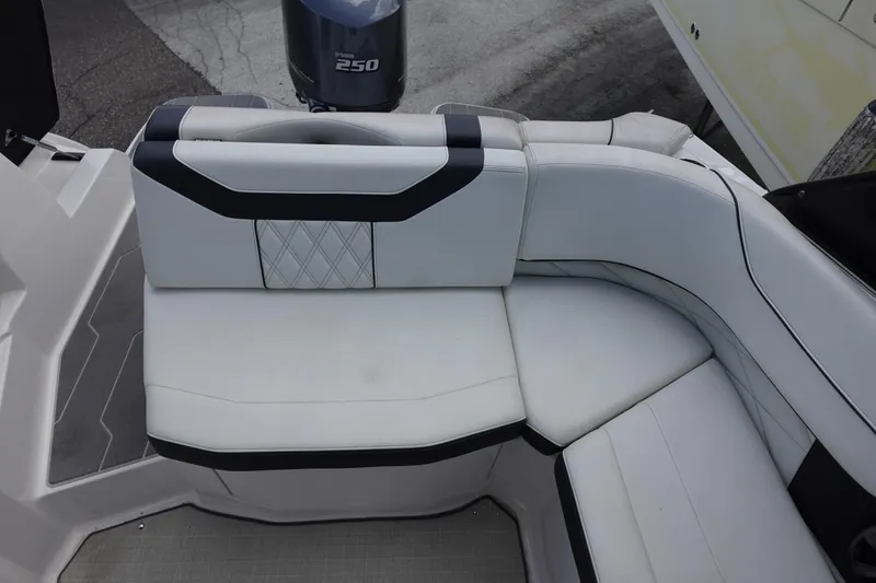 Slide: The Image of 2021 Regal 23 OBX boat interior with white cushioned seating and Yamaha 250 outboard motor. - 46