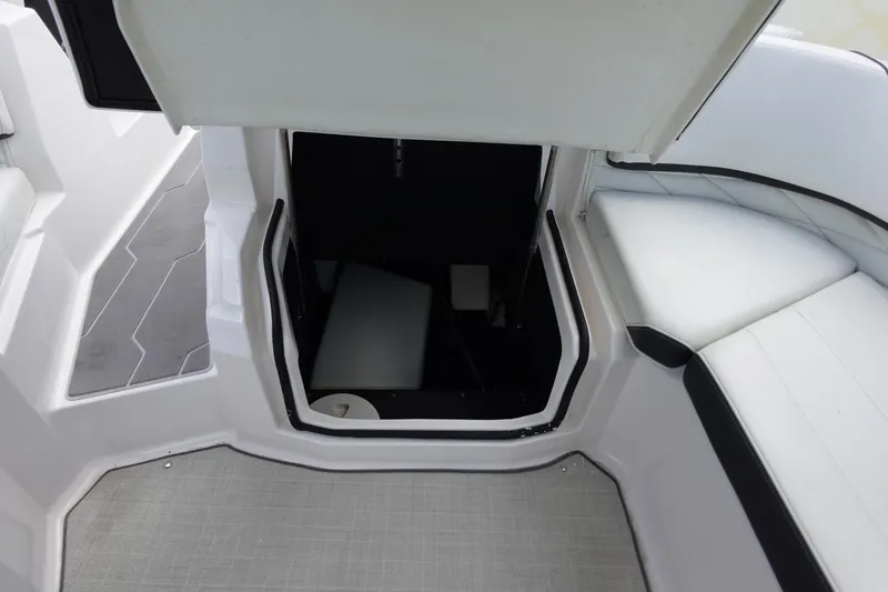Slide: The Image of 2021 Regal 23 OBX boat interior storage compartment with seating and flooring. - 47