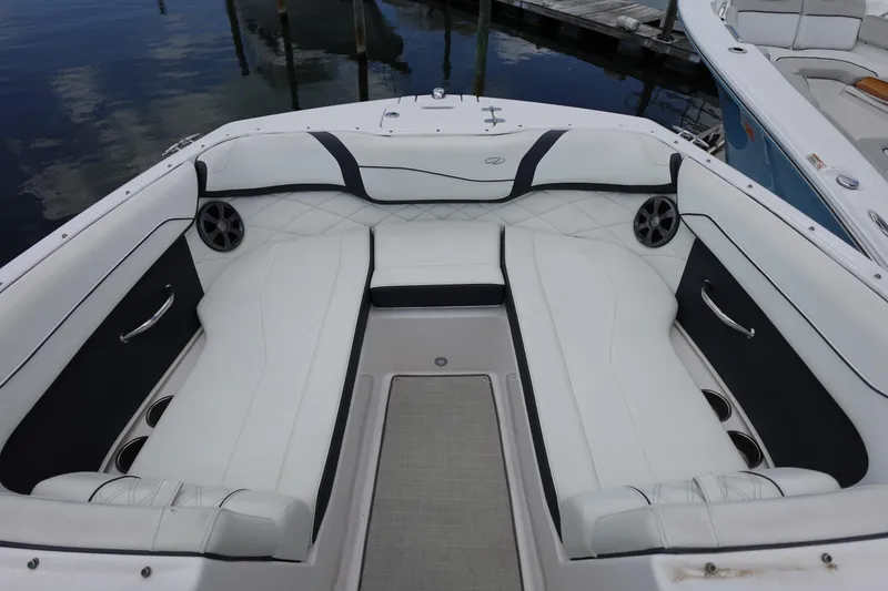 Slide: The Image of 2021 Regal 23 OBX boat interior with white cushioned seating and cup holders. - 5