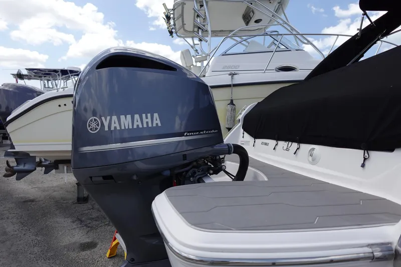 Slide: The Image of 2021 Regal 23 OBX boat with Yamaha outboard motor in marina setting. - 53