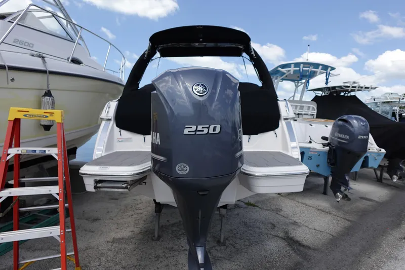 Slide: The Image of 2021 Regal 23 OBX boat with Yamaha 250 outboard motor, docked outdoors. - 54