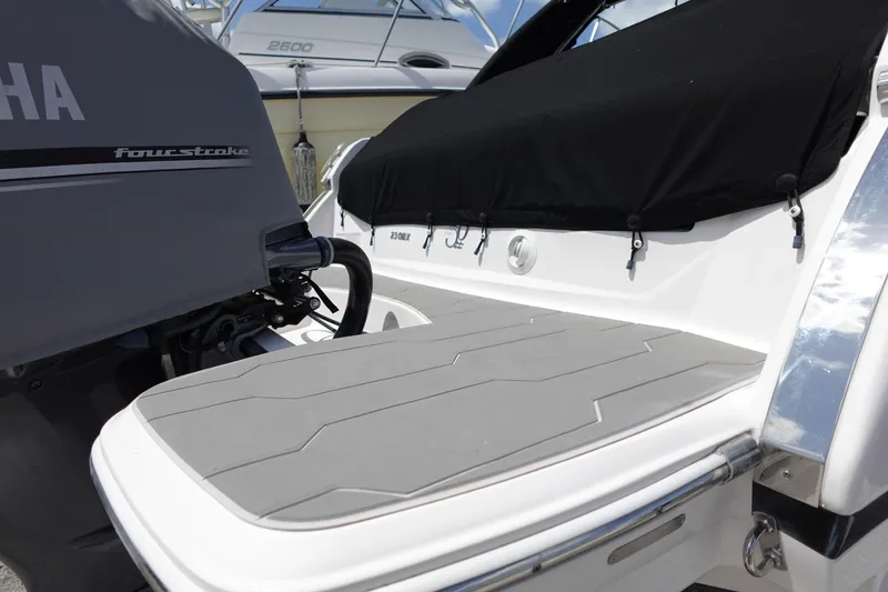 Slide: The Image of 2021 Regal 23 OBX boat with Yamaha four-stroke engine, featuring sleek swim platform. - 57