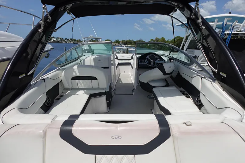 Slide: The Image of 2021 Regal 23 OBX boat interior with white seating and steering wheel. - 6