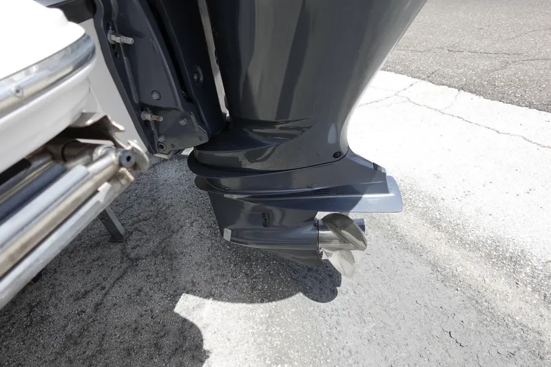 Slide: The Image of Outboard motor of a 2021 Regal 23 OBX boat on pavement. - 62