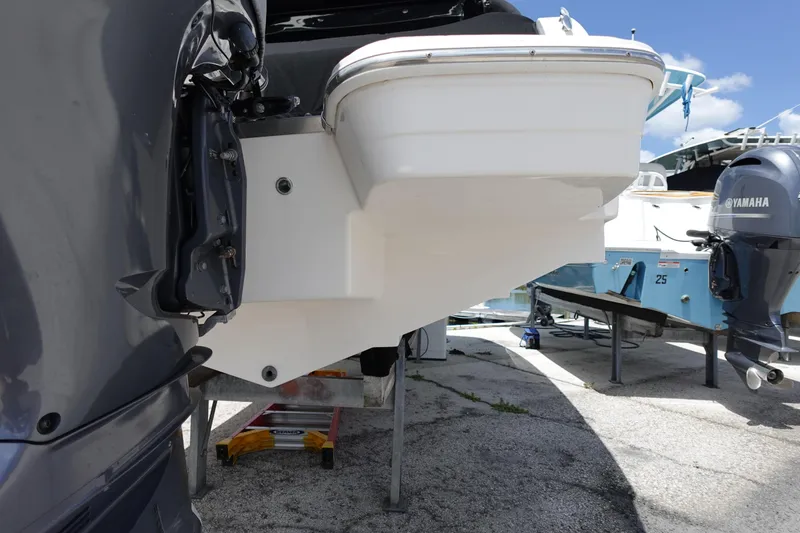 Slide: The Image of 2021 Regal 23 OBX boat with Yamaha outboard motor in a marina setting. - 64