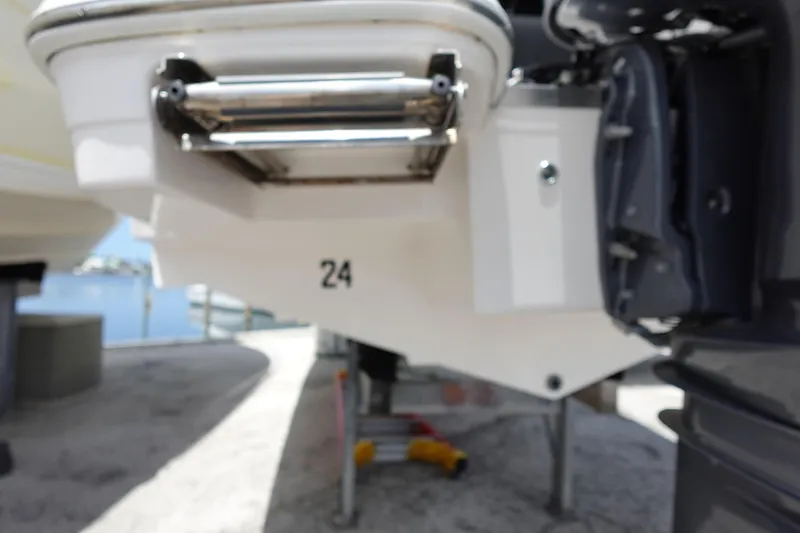 Slide: The Image of Rear view of a 2021 Regal 23 OBX boat with ladder and number 24. - 65