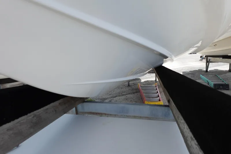 Slide: The Image of 2021 Regal 23 OBX boat hull on trailer, close-up view. - 68