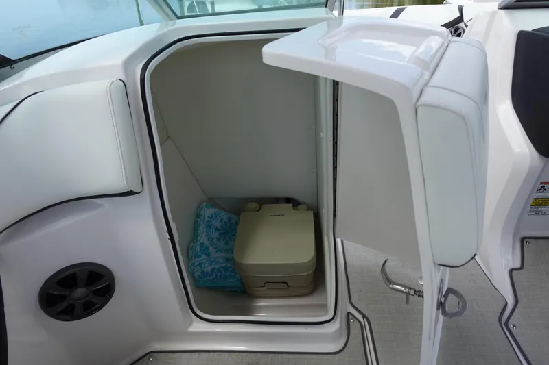 Slide: The Image of 2021 Regal 23 OBX boat interior with compact toilet and storage space. - 8