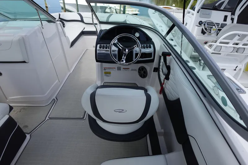 Slide: The Image of 2021 Regal 23 OBX boat interior with steering wheel and seating. - 9
