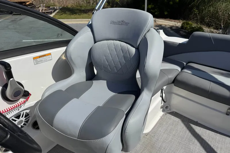 Slide: The Image of 2023 NauticStar 243 DC boat seat with gray upholstery and ergonomic design. - 15