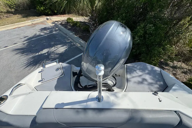 Slide: The Image of 2023 NauticStar 243 DC boat with outboard motor in a parking area. - 17