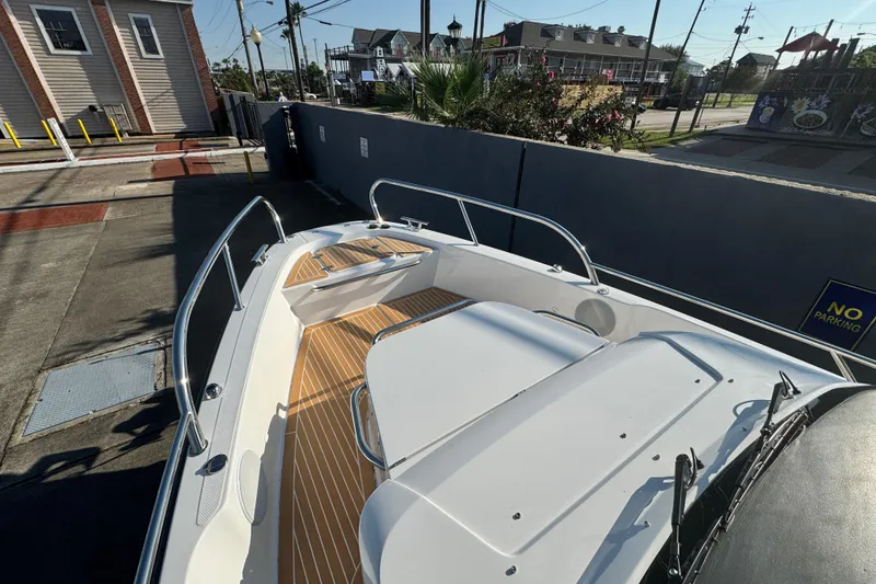 Slide: The Image of 2025 Nimbus Tender 8 boat with sleek design, docked in urban setting. - 16