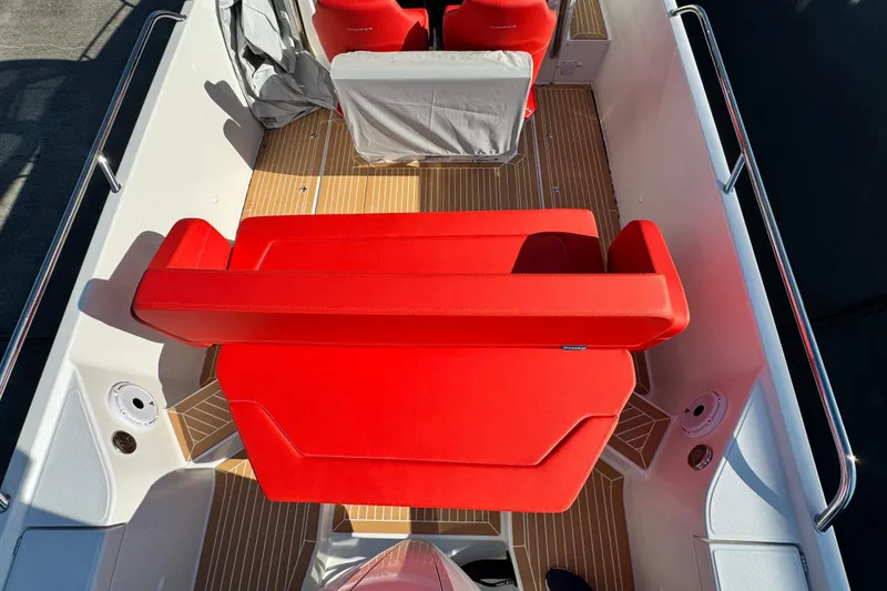 Slide: The Image of 2025 Nimbus Tender 8 boat interior with vibrant red seating and sleek design. - 31