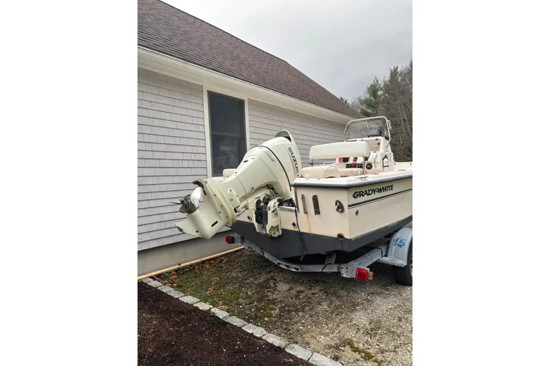 Slide: The Image of 2001 Grady-White Fisherman 180 boat on trailer beside house. - 11
