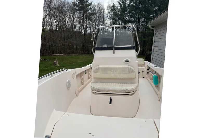 Slide: The Image of 2001 Grady-White Fisherman 180 boat interior with seating and console, surrounded by trees. - 4