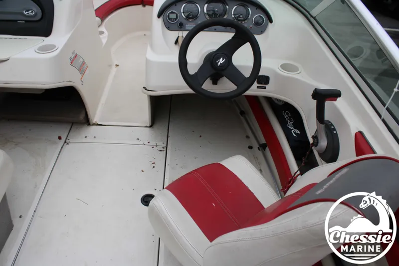 Slide: The Image of Interior of a 2006 Sea Ray 205 Sport boat with steering wheel and seats. - 10