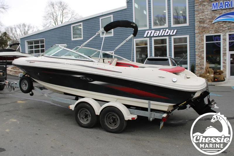 Slide: The Image of 2006 Sea Ray 205 Sport boat on trailer in front of building. - 4