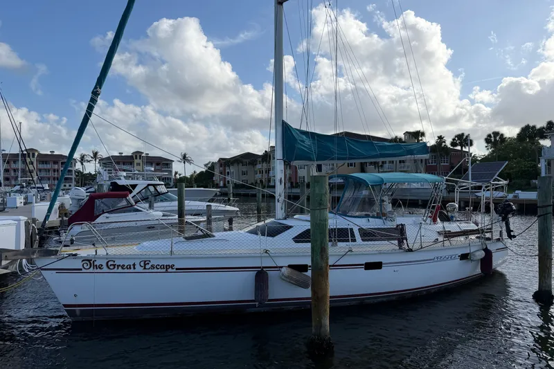 The Image of Sailboat "The Great Escape," 1992 Hunter Passage 42, docked at marina under blue sky. - 0