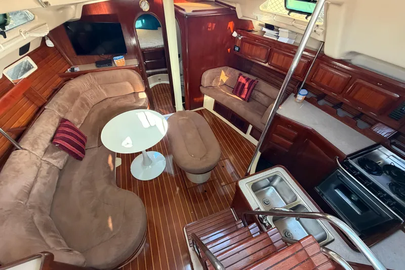 Slide: The Image of Interior of 1992 Hunter Passage 42 sailboat with cozy seating and kitchen area. - 17