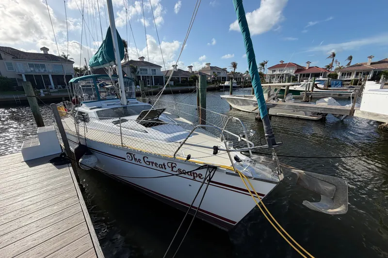Slide: The Image of 1992 Hunter Passage 42 sailboat docked, named "The Great Escape," in a marina setting. - 2