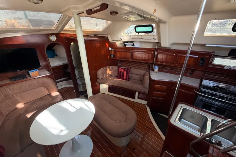 Slide: The Image of Interior of 1992 Hunter Passage 42 sailboat with cozy seating and wooden cabinetry. - 20