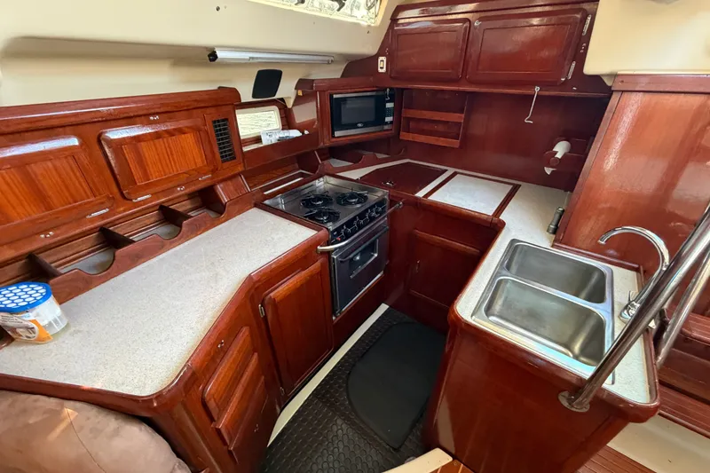 Slide: The Image of Interior of 1992 Hunter Passage 42 yacht kitchen with wooden cabinetry and dual sink. - 22
