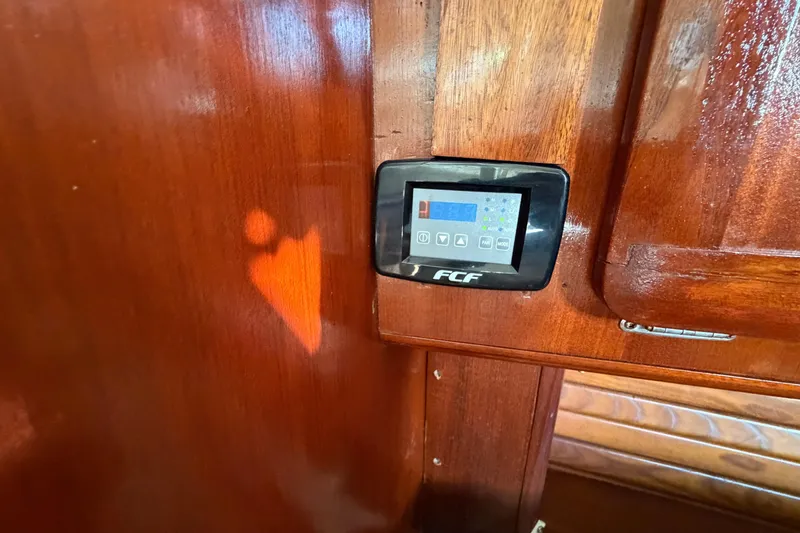 Slide: The Image of Control panel on 1992 Hunter Passage 42 yacht with wooden interior. - 25