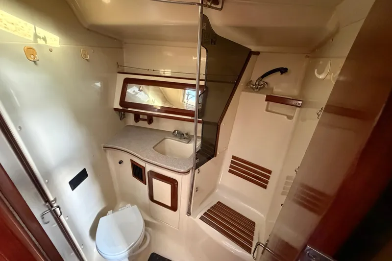 Slide: The Image of 1992 Hunter Passage 42 yacht bathroom with shower, sink, and toilet. - 27
