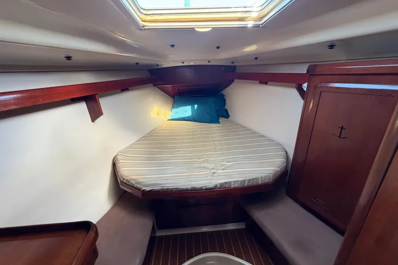 Slide: The Image of Cozy cabin interior of 1992 Hunter Passage 42 sailboat with skylight and wooden accents. - 28