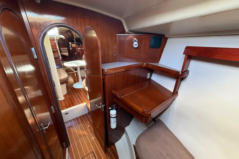 Slide: The Image of Interior of 1992 Hunter Passage 42 yacht with wooden cabinetry and seating area. - 29