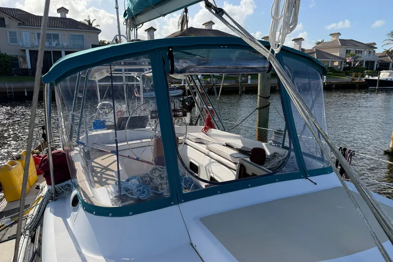 Slide: The Image of Sailboat Hunter Passage 42, 1992 model, docked in a marina with clear skies. - 3